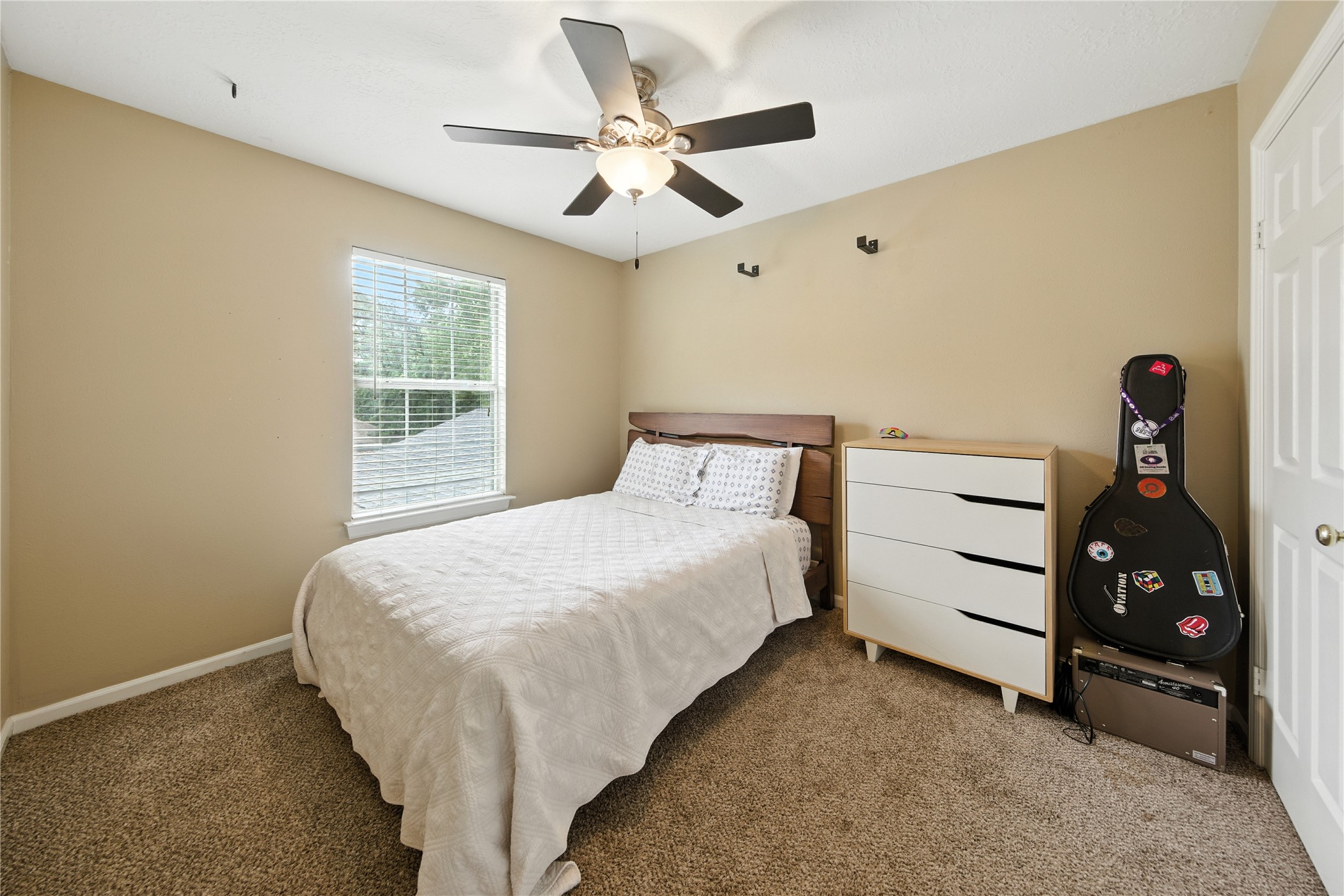 115 Regency Way Conroe, TX 77304 - Photo 27 of 32 a bedroom with a bed and a ceiling fan