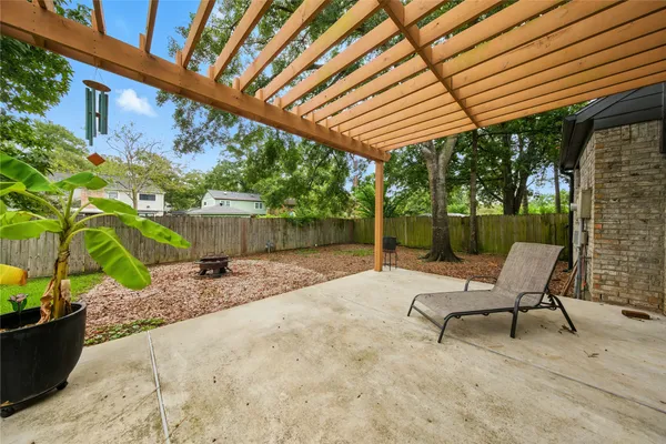 a view of patio with a table and chairs under an umbrella