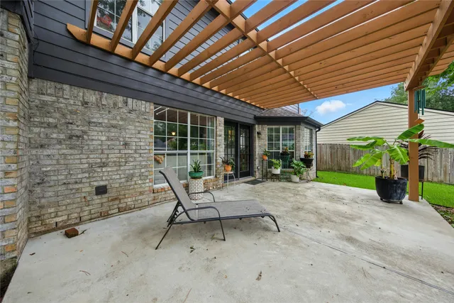 a view of a patio with table and chairs and potted plants