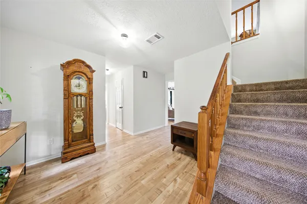 a view of an entryway with wooden floor