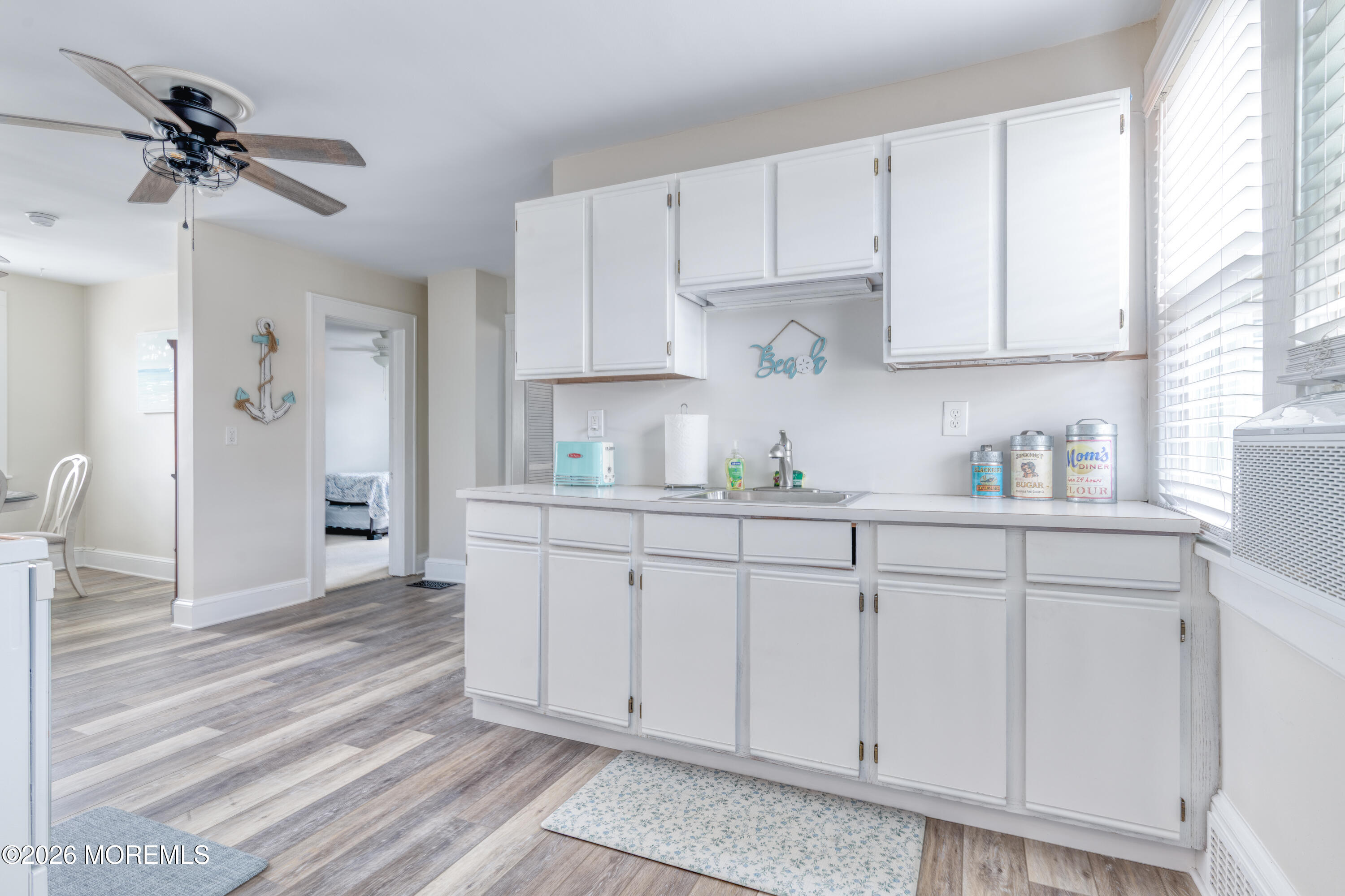 2 Via Ripa, Unit 2 Sea Bright, NJ 07760 - Photo 20 of 27 a kitchen with white cabinets and white appliances