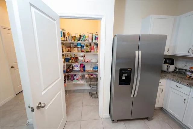 a kitchen with stainless steel appliances granite countertop a refrigerator stove and sink
