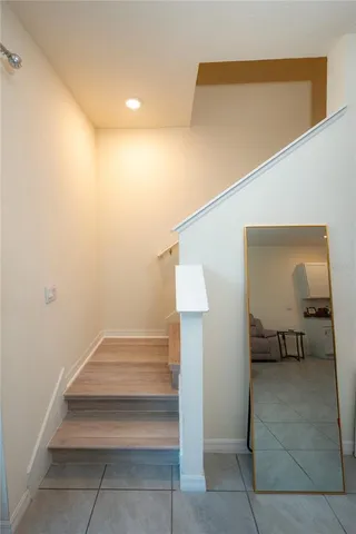 a view of a hallway with entryway and stairs