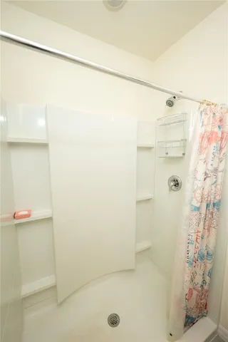 a bathroom with a double vanity sink toilet and shower