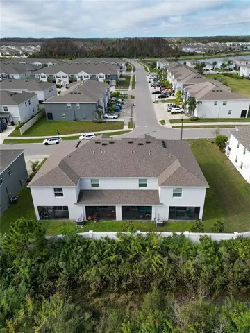 an aerial view of a house with a lake view