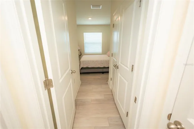 a bedroom with a bed and a flat tv screen on the dresser