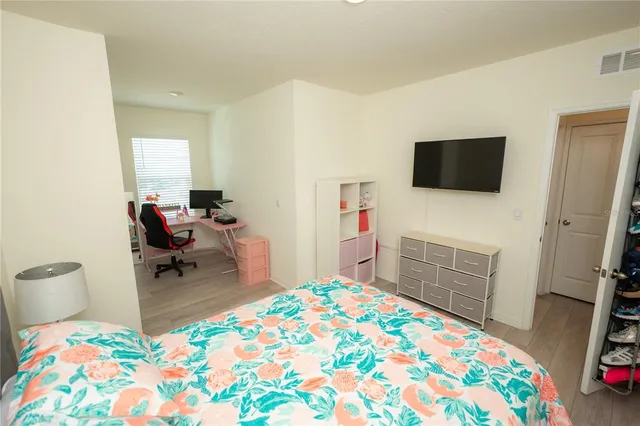 a view of a lake with boats and palm trees