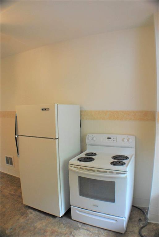 518 Middle Avenue Wilmerding, PA 15148 - Photo 12 of 13 a view of washer and dryer with kitchen in the background