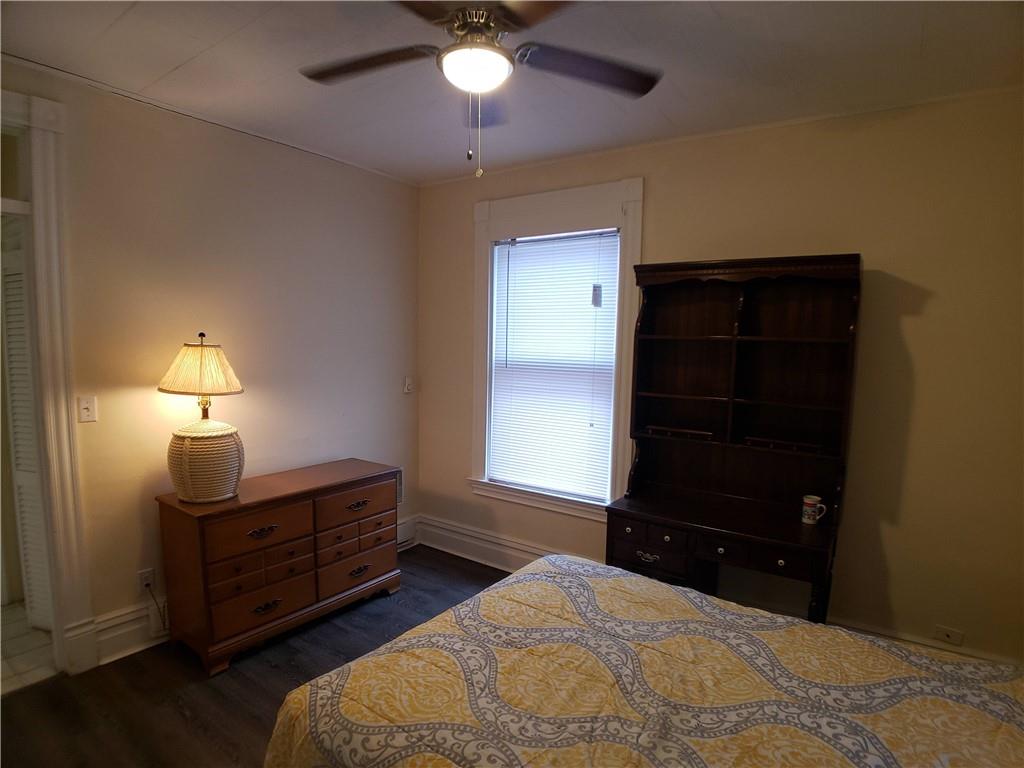 518 Middle Avenue Wilmerding, PA 15148 - Photo 7 of 13 a bedroom with a bed and a lamp on the dresser