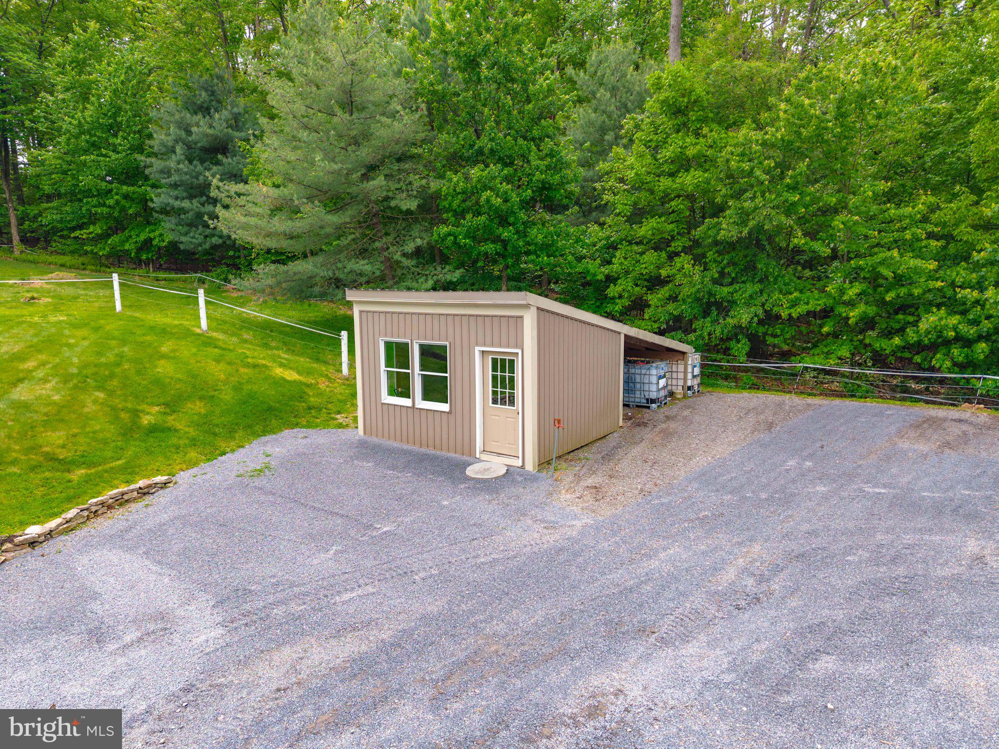 2201 Blain Road Loysville, PA 17047 - Photo 65 of 89 Charming shed nestled in lush greenery.