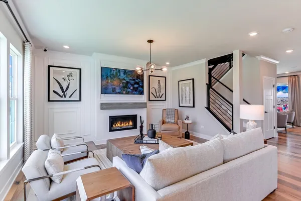 a living room with furniture fireplace and a window