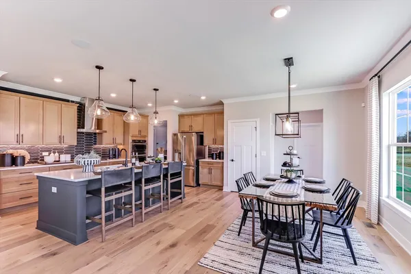 a large kitchen with lots of counter space and dining table