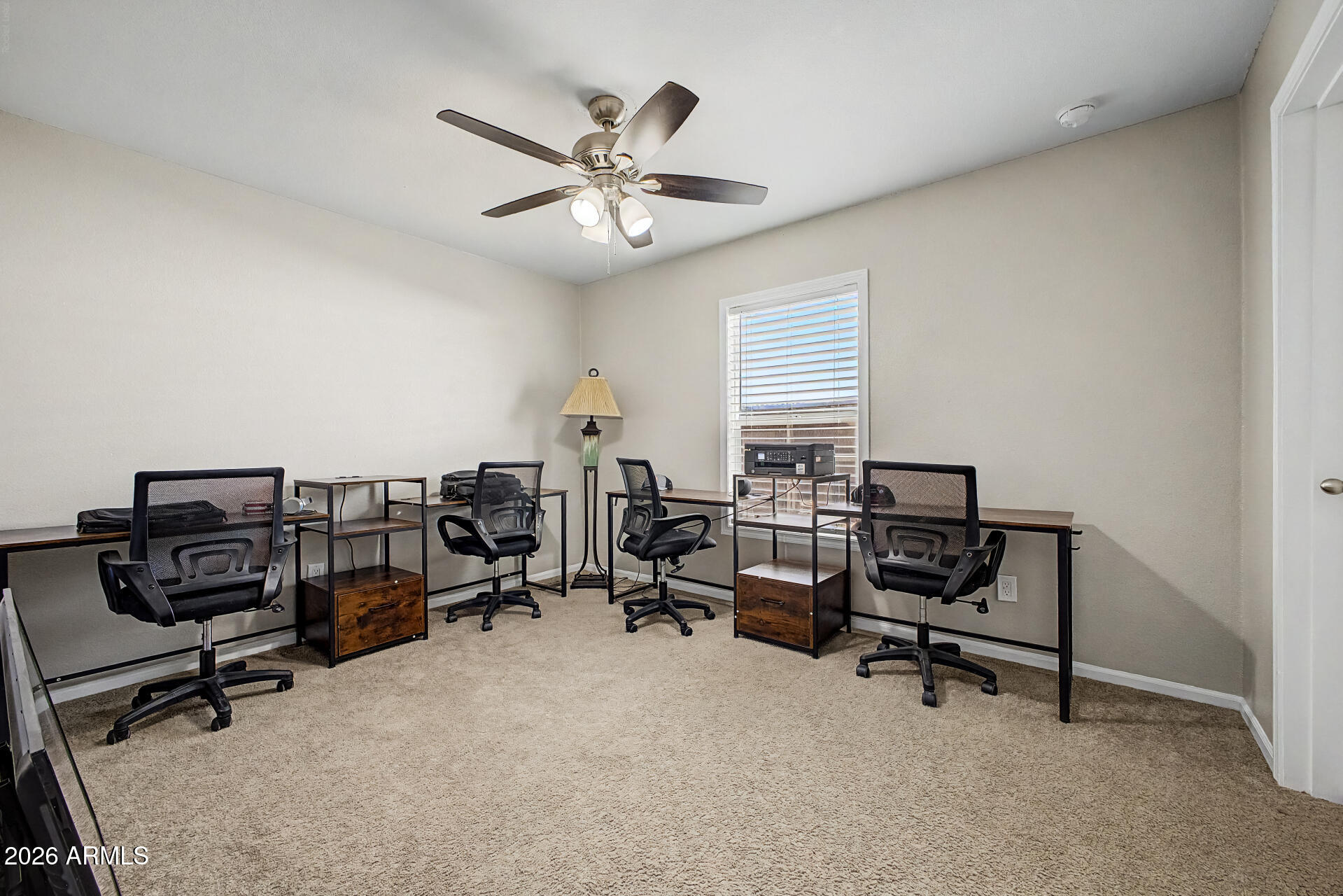 22417 West Dove Valley Road Wittmann, AZ 85361 - Photo 27 of 53 a view of a workspace with furniture and a window