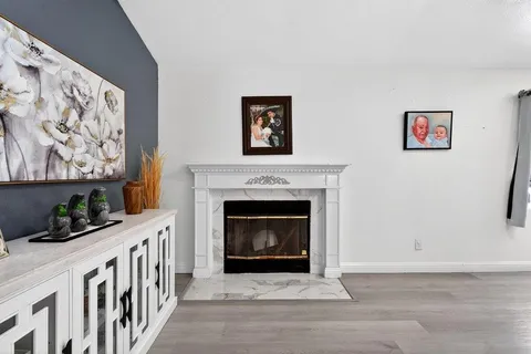 a living room with a fireplace and furniture