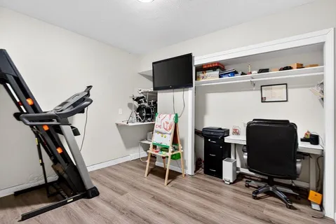 a view of a workspace with furniture and a flat screen tv