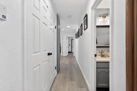 a bathroom with a sink vanity mirror and toilet