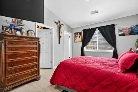 a view of walk in closet with clothes