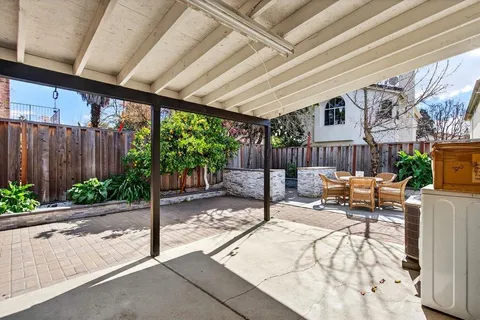 a view of a chairs and a table in the patio