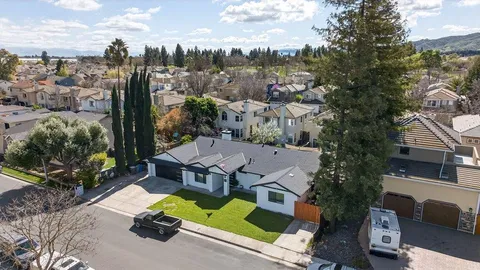 an aerial view of residential houses with outdoor space and swimming pool