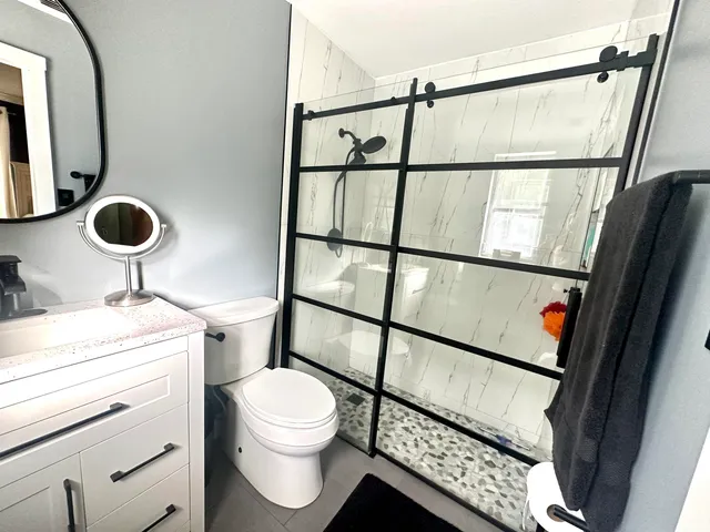 a large bed sitting in a bedroom next to a window