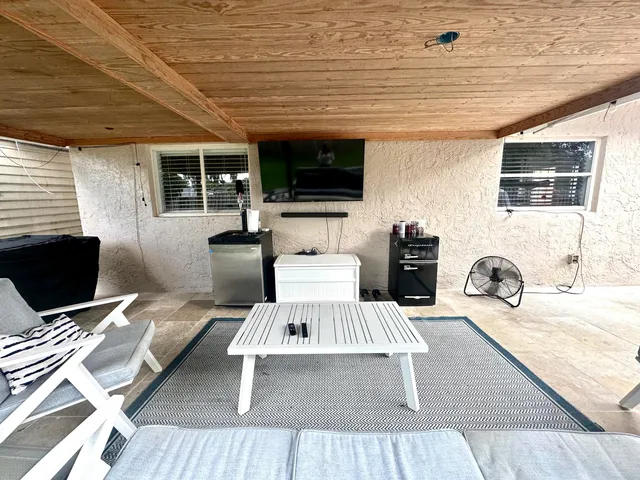 an aerial view of a house with a swimming pool and a yard