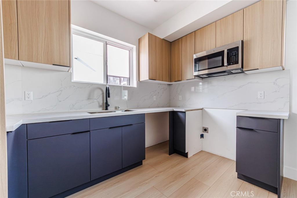 13461 Beach Avenue, Unit 1/2 Marina del Rey, CA 90292 - Photo 12 of 33 a kitchen with stainless steel appliances granite countertop a sink and a microwave