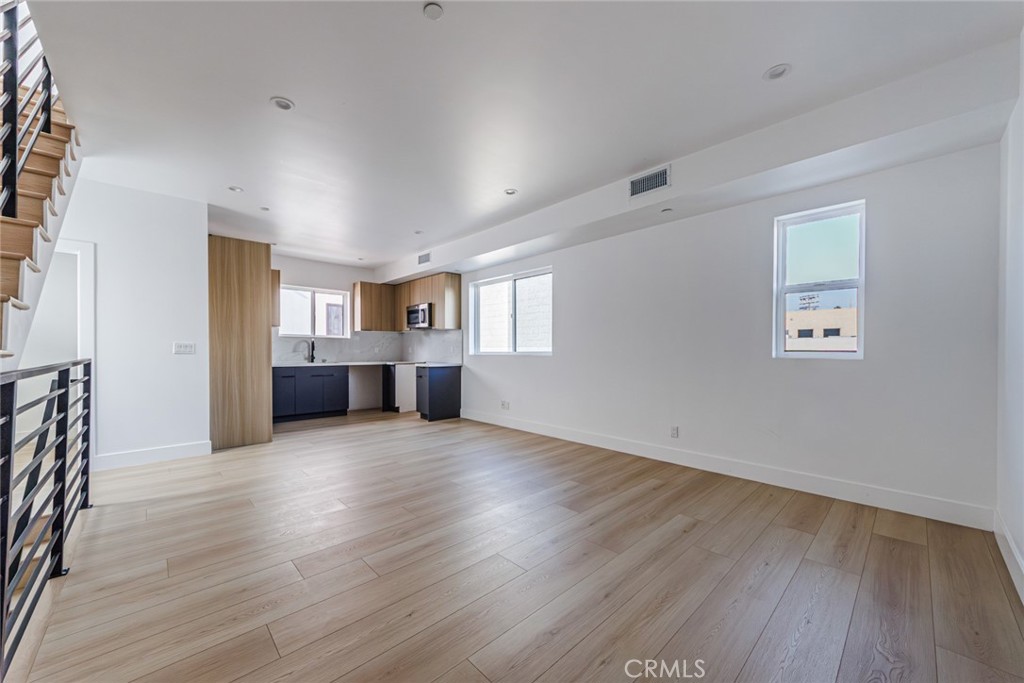 13461 Beach Avenue, Unit 1/2 Marina del Rey, CA 90292 - Photo 15 of 33 an empty room with wooden floor and windows