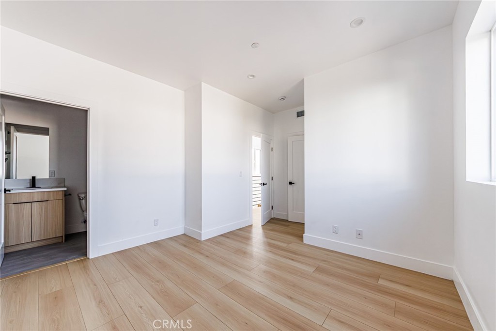 13461 Beach Avenue, Unit 1/2 Marina del Rey, CA 90292 - Photo 31 of 33 a view of a room with wooden floor and white walls