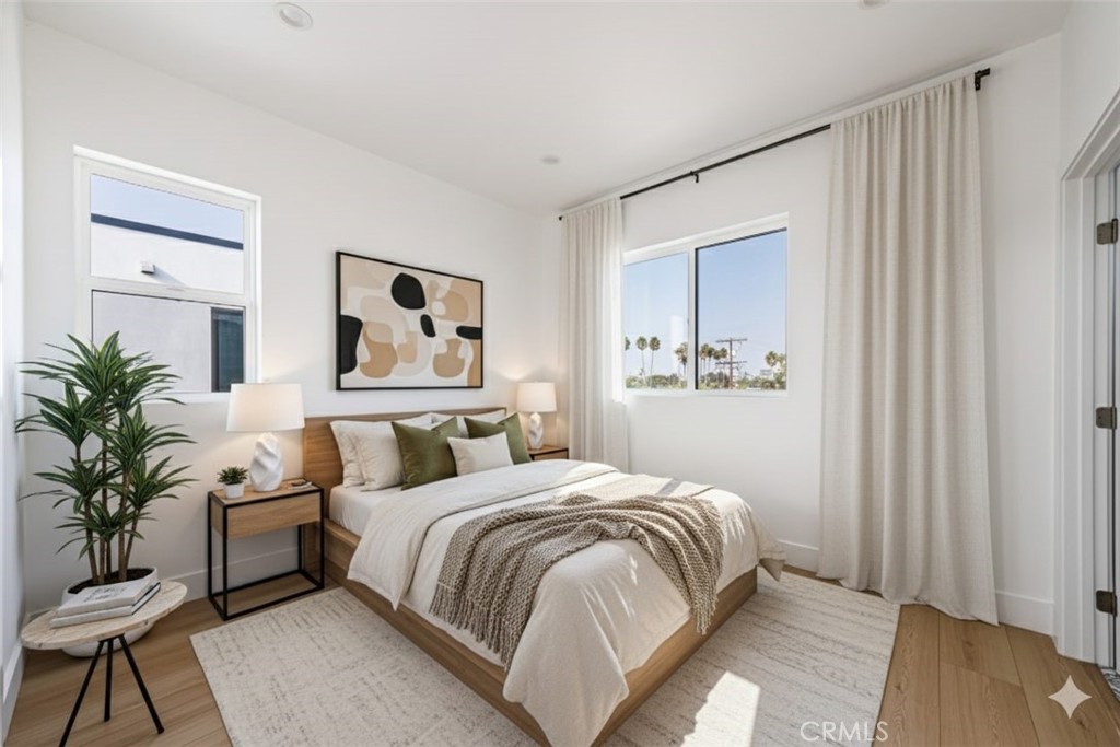13461 Beach Avenue, Unit 1/2 Marina del Rey, CA 90292 - Photo 4 of 33 a bedroom with a large bed and a potted plant