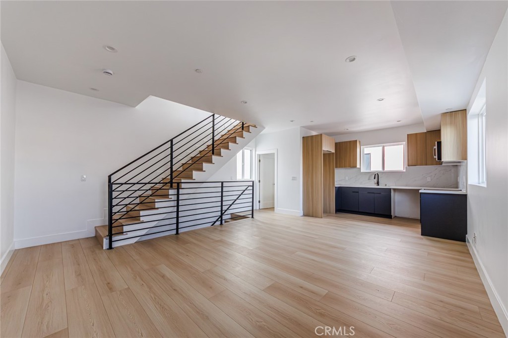 13461 Beach Avenue, Unit 1/2 Marina del Rey, CA 90292 - Photo 8 of 33 a view of an empty room with wooden floor and a kitchen