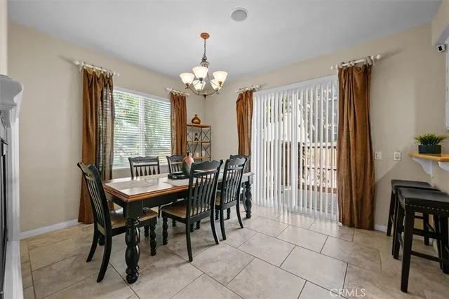 a view of a dining room with furniture and a chandelier