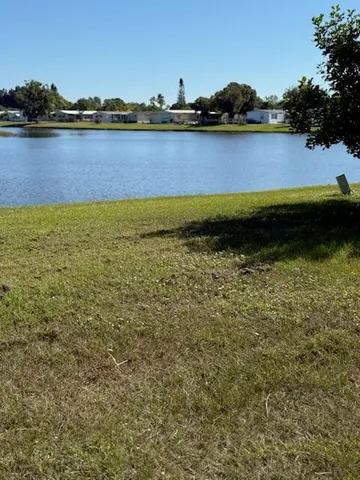 a view of a lake with houses in the back
