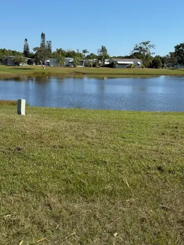 a view of a lake with boats and trees in the background