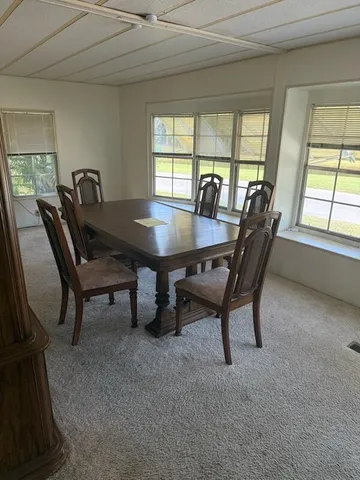 a view of a dining room with furniture and window