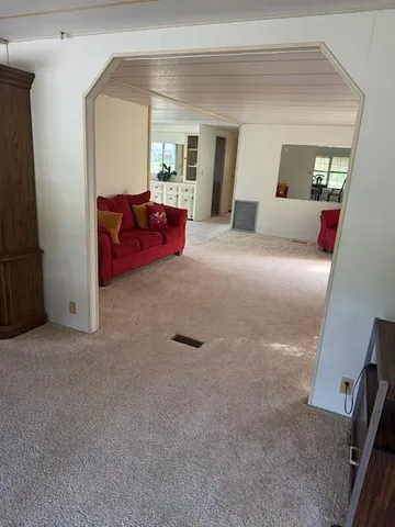 a living room with furniture and a large mirror