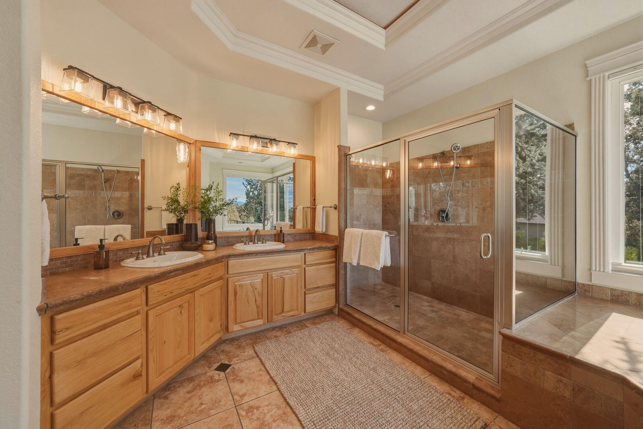 21450 Dale Road Bend, OR 97701 - Photo 36 of 75 A spa-inspired bath with dual vanities, tile shower, soaking tub, and fireplace.