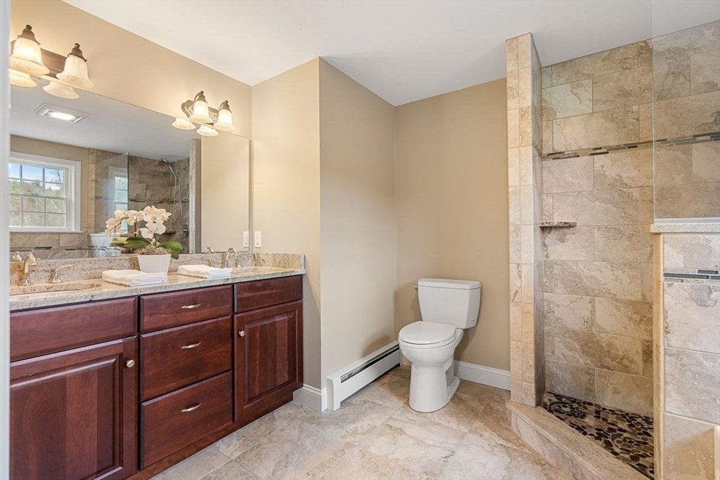 501 Great Road Stow, MA 01775 - Photo 27 of 32 a bathroom with a toilet a sink and mirror