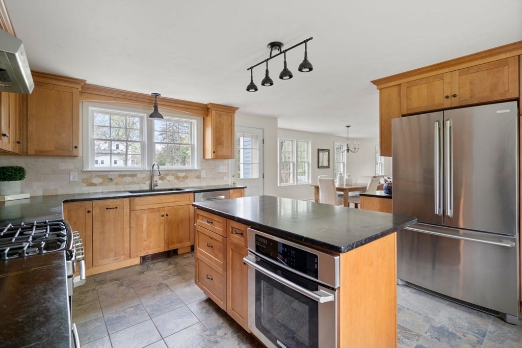 501 Great Road Stow, MA 01775 - Photo 3 of 32 a kitchen with stainless steel appliances granite countertop a sink stove and refrigerator