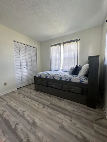 a bedroom with a bed window and table
