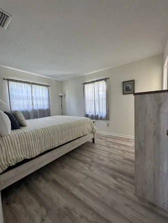 a spacious bedroom with a bed and a window