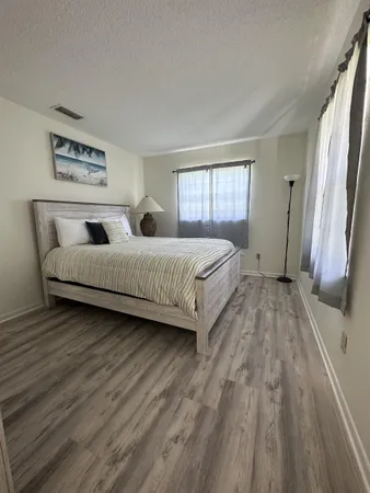 a bedroom with a bed and a large window