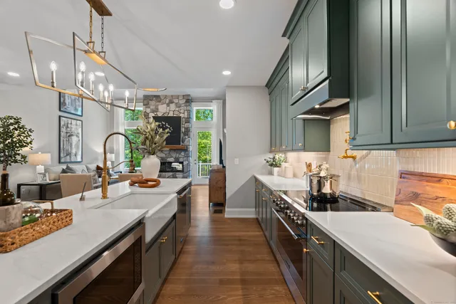 a large kitchen with stainless steel appliances lots of counter space and a sink