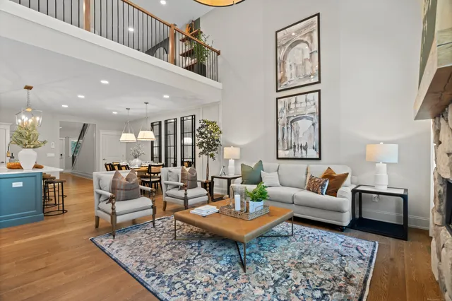 a living room with furniture a rug and a table