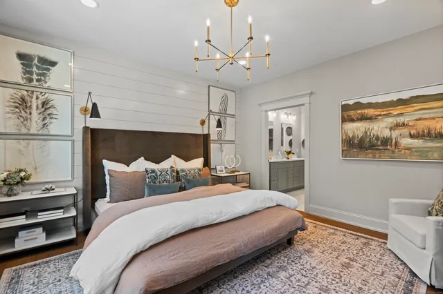 a bedroom with a bed and a chandelier