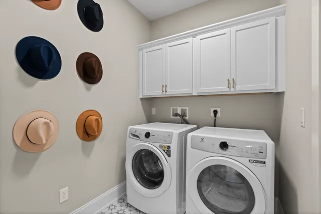 a view of cabinets with washer and dryer