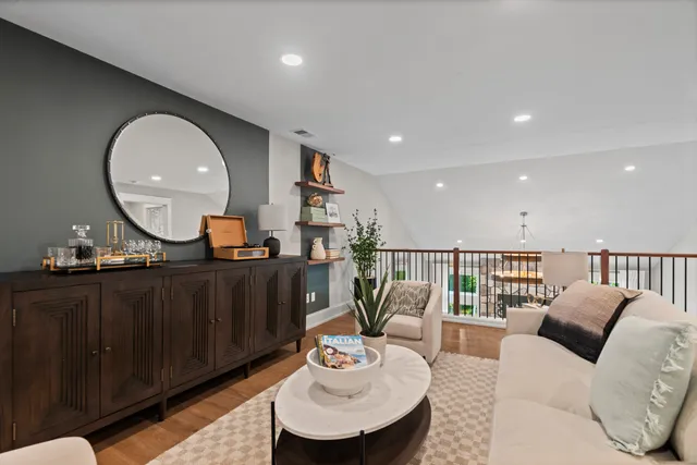 a living room with furniture and a mirror