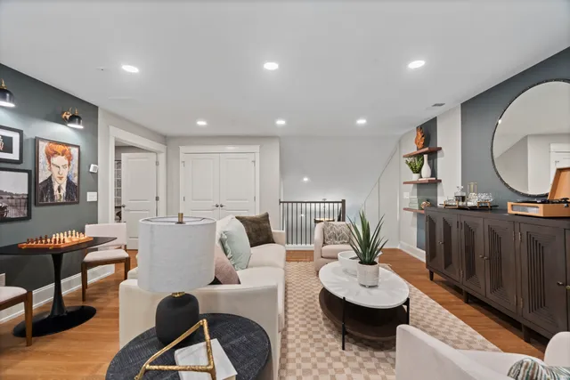 a living room with furniture and a wooden floor