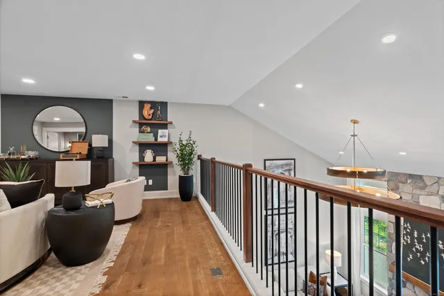 a living room with furniture a rug and a chandelier