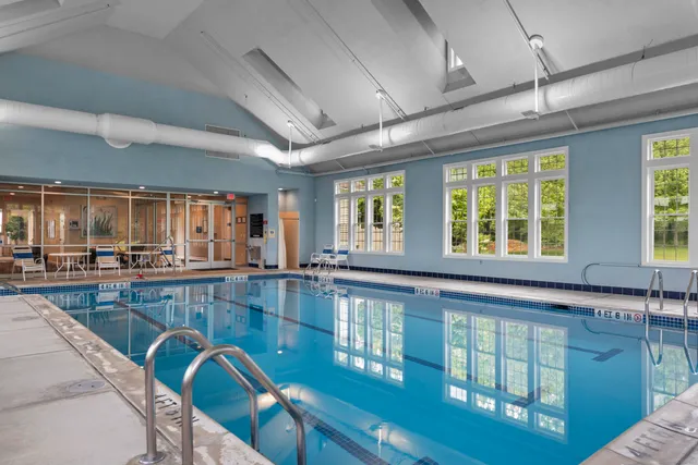a front view of house with outdoor seating and lake view
