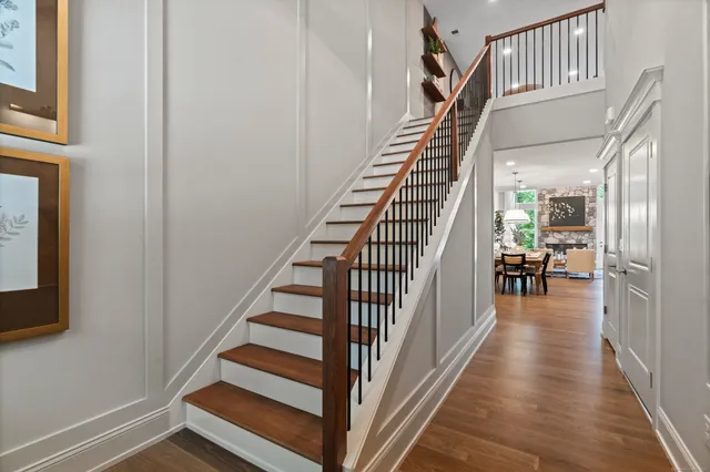 a view of a hallway with wooden floor and staircase